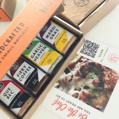Image showing open gift box showing 4 bottles of grilling spice flavors along with insert card that is included in the box
