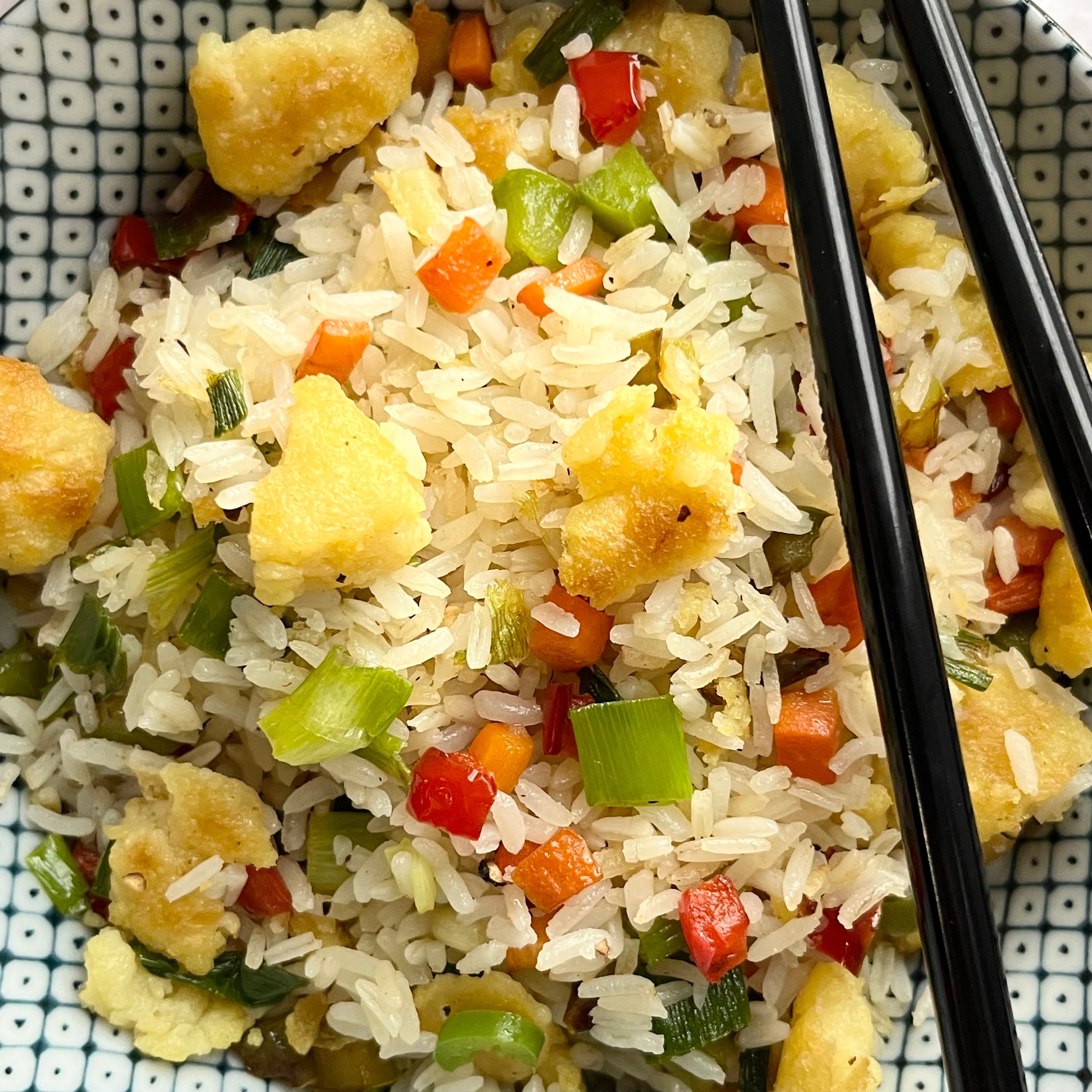 Fried Rice with veggies and nummy nibbles mung based egg mix along with chopsticks